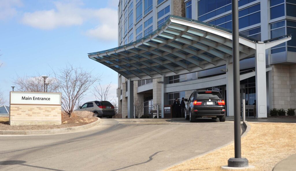 Hospital visitor parking lot with valet drop‑off zone.