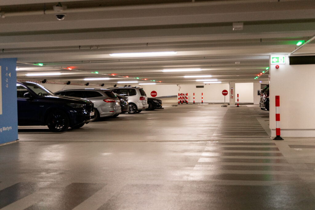 Parking garage interior showing clear directional signage and color-coded wayfinding.